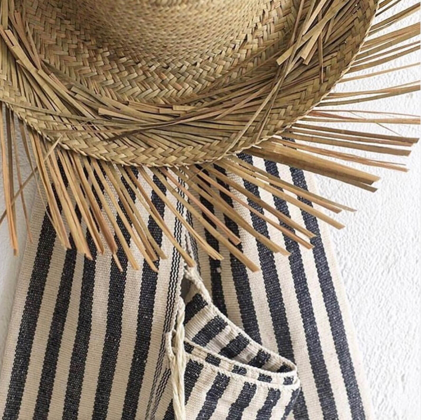 A straw hat and a Karen handwoven cotton shoulder bag. Keeping it stylish yet simple.